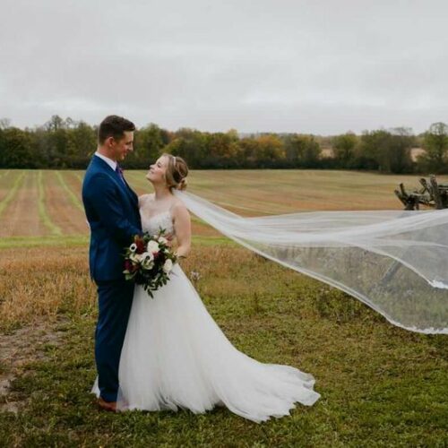 Floral Reef Designs - Ottawa Florist - Bride and Groom Standing in Field