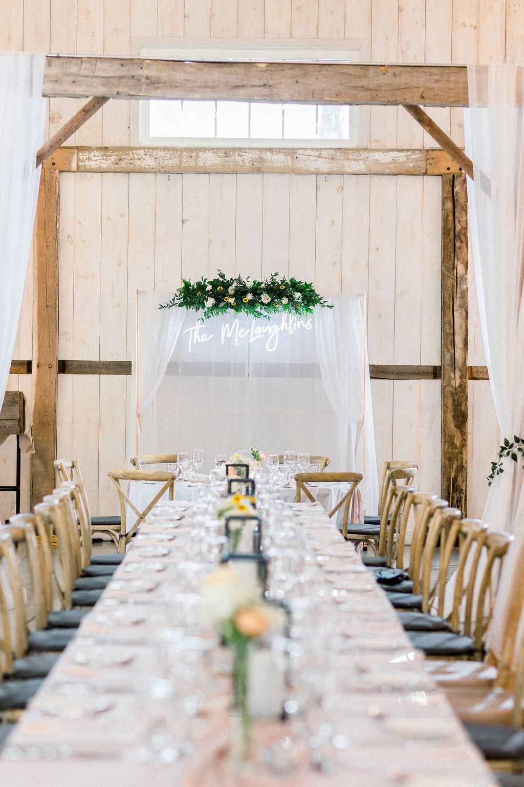 Floral Reef Designs Ottawa Wedding Florist - Amy Pinder Photography - Stonefields Estate wedding - neon signage with complementary greenery and floral installation overlooking table with small bud vases of pastel flowers